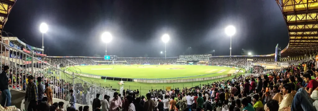PSL live score — Gaddafi Stadium lit up at night during a PSL evening match