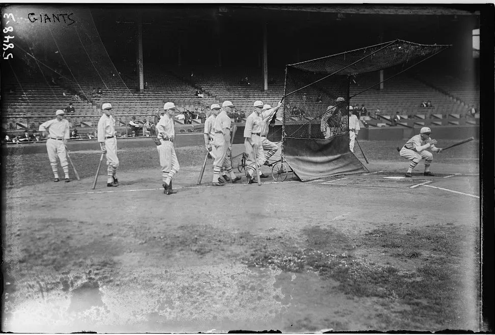 Baseball players at a batting cage in 1923, a vintage tryout scene like MLB open tryouts 2026